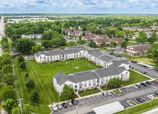 A large white building with a green lawn in front of it.