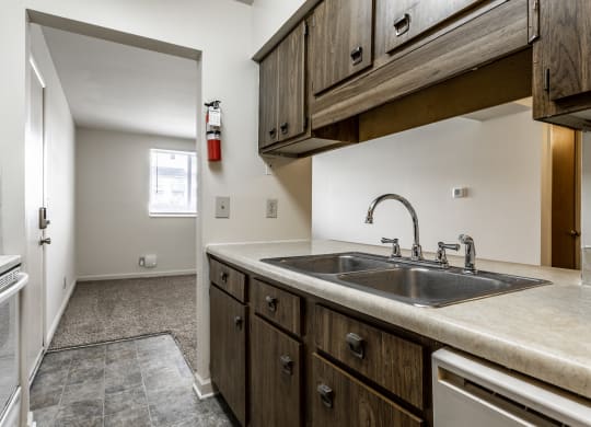 a kitchen with a sink and a stove and a refrigerator at Bay Pointe Apartments in Lafayette, 47909