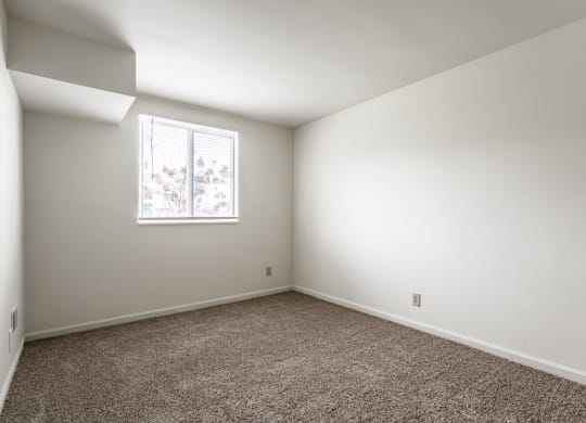 an empty room with carpet and a window at Bay Pointe Apartments in Lafayette, IN 47909