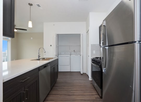 Kitchen with Washer & Dryer at Meadowbrooke Apartment Homes in Kentwood, MI 49512