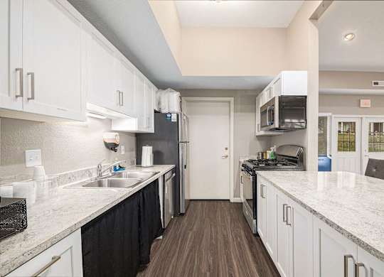 a clubhouse kitchen with white cabinets at Black Sand Apartment Homes, Nebraska