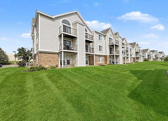 Multi story apartment buildings with green lawn at Black Sand Apartments Homes, Lincoln, NE 68504
