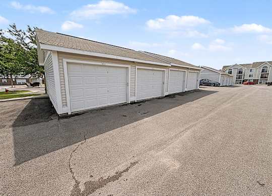 Row of detached garages with white doors at Black Sand Apartments Homes, Lincoln, NE