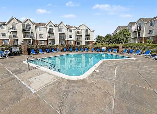 Community swimming pool with lounge chairs and apartment views at Black Sand Apartments Homes, Nebraska, 68504
