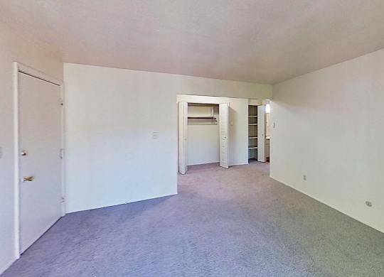 A living room and a dining room with a large closet at Briarwood Apartments in Benton Harbor, MI
