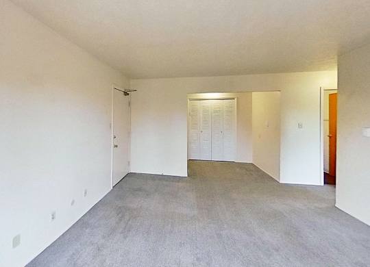 A large empty living and dining room at Briarwood Apartments in Benton Harbor, MI