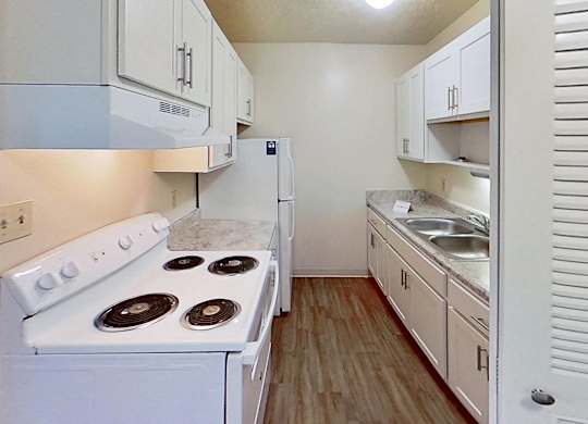 An upgraded kitchen with white cabinets at Briarwood Apartments in Benton Harbor, MI
