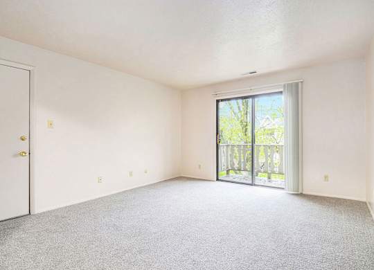 open living room with a balcony at Briarwood Apartments, Benton Harbor, 49022
