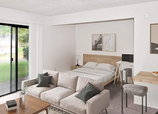 A studio living room with a slider to a patio at Brookside Apartments, Springfield