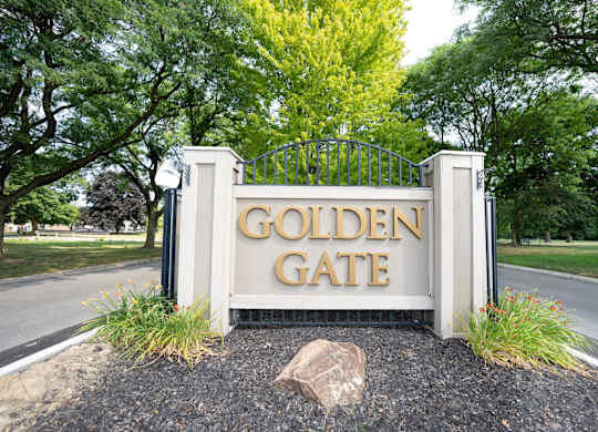 A sign that says "Golden Gate" is in front of a gate.