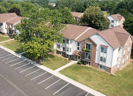 A parking lot in front of a building with trees.