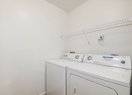 a laundry room with a full size washer and dryer  at Black Sand Apartment Homes, Nebraska