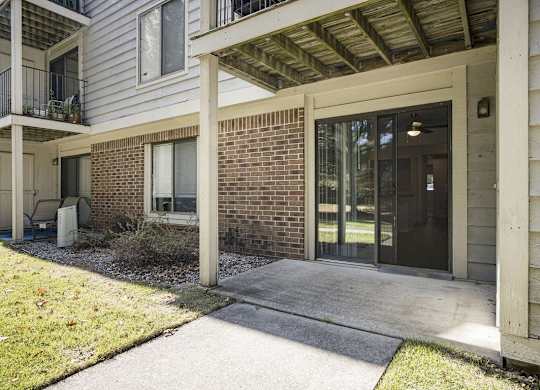 patio with slider and enclosed storage  at Byron Lakes Apartments, Byron Center, MI