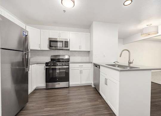 Stylish Kitchen with Breakfast Bar at Byron Lakes Apartments, Byron Center, MI, 49315