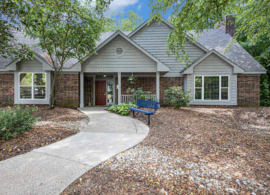 A leasing office and community building with landscaping in front at Byron Lakes Apartments, Byron Center, MI
