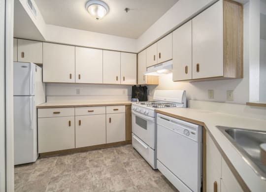 a kitchen with white appliances at Canal 2 Apartments, Lansing, 48917