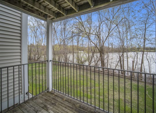 the view from the balcony of an apartment overlooking a pond at Canal 2 Apartments in Lansing, MI