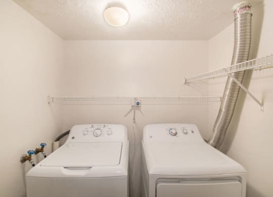 a laundry room with full size washer and a dryer at Canal 2 Apartments, Lansing, Michigan