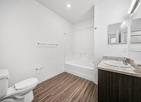 a bathroom with a toilet sink and showe rat Chase Creek Apartment Homes, Alabama, 35811