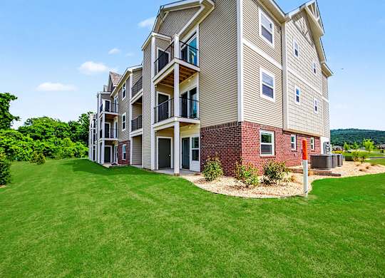 The back of an apartment building with balconies and patios at Chase Creek Apartment Homes, Huntsville, AL, 35811