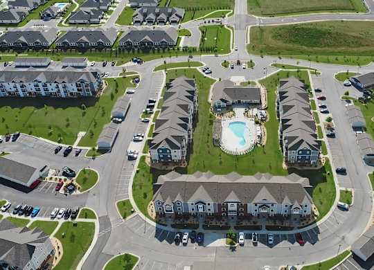 A bird's eye view of an apartment community with buildings and a swimming pool at Chase Creek Apartment Homes, Huntsville, 35811