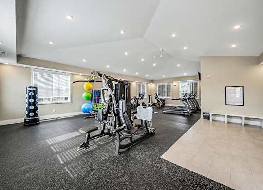 A spacious gym with a variety of equipment including treadmills, weights, and exercise balls at Chase Creek Apartment Homes, Huntsville, AL, 35811