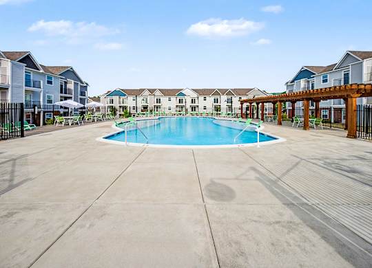 A large swimming pool with sundeck and a pergola with seating at Chase Creek Apartment Homes, Huntsville, AL, 35811