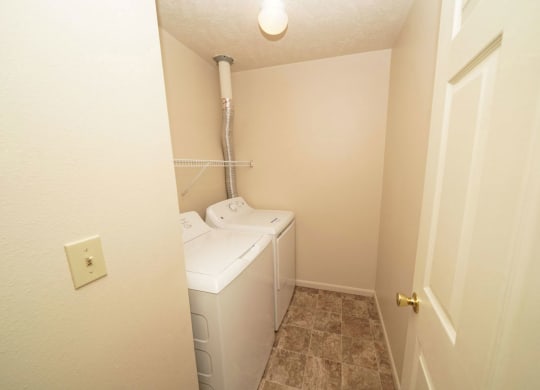 Laundry room with washer and dryer in it at Canal Club Apartments, Lansing, MI, 48917