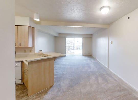 a living room and dining room leading to a kitchen at Colonial Pointe at Fairview Apartments, Bellevue, Nebraska
