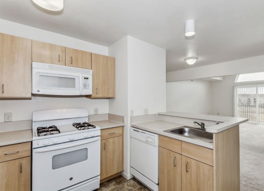 Two bedroom kitchen with a stove microwave and dishwasher at Colonial Pointe at Fairview Apartments, Bellevue, 68123