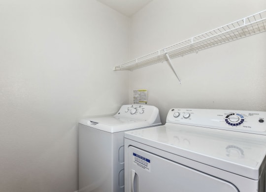 Laundry room with washer and a dryer at Colonial Pointe at Fairview Apartments, Bellevue, NE, 68123