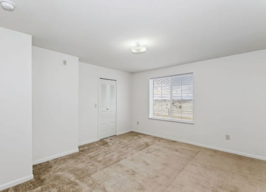 Bedroom with closet and a window at Colonial Pointe at Fairview Apartments, Bellevue, Nebraska