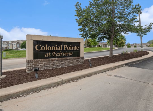 entrance sign for Colonial Pointe at Fairview Apartments in Bellevue, NE