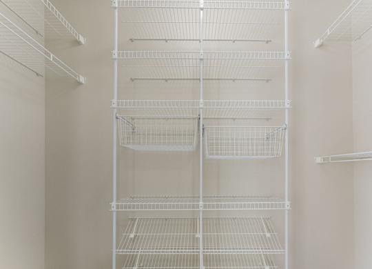 A walk-in closet with wardrobe organizers at Colonial Pointe at Fairview Apartments, Bellevue, 68123