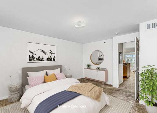 A bedroom with a bed, nightstand, and a painting on the wall at Colonial Pointe at Fairview Apartments, Bellevue, Nebraska