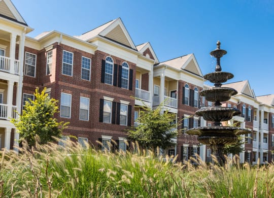 Exterior Shot of Buildings with Outdoor Fountain at Alexandria of Carmel Apartments, Carmel, IN