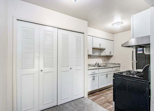 A kitchen with white cabinets and stainless steel appliances at Concord Place Apartments, Kalamazoo, MI