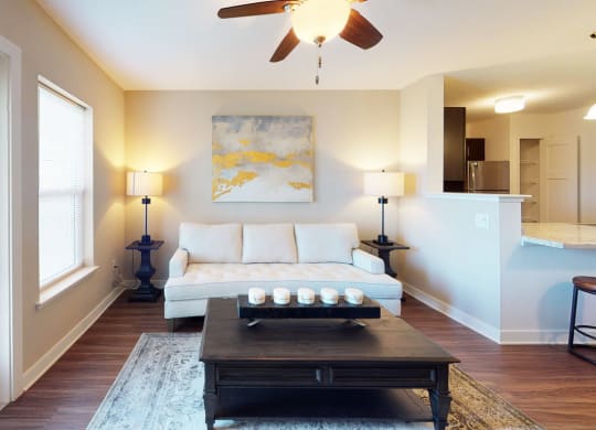 a living room with a large window and a door to private patio at Copper Creek Apartment Homes in Maize, 67101