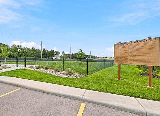 Dog park with fencing and rules signage at Copper Creek Homes Apartments, Maize, Kansas