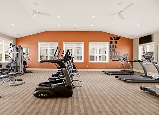 Fitness center with weight machines at Copper Creek Homes Apartments, Maize, KS