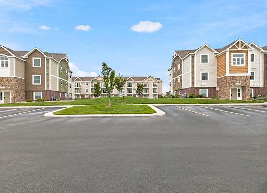 Residential community street view with center median at Copper Creek Homes Apartments, Maize, Kansas