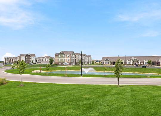 Apartment community with pond and fountain at Copper Creek Homes Apartments, Maize, KS 67101