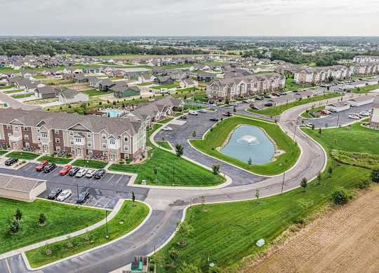 Aerial view of residential community with pond at Copper Creek Homes Apartments, Kansas