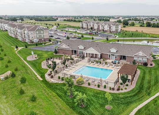 Aerial view of clubhouse pool and surrounding green space at Copper Creek Homes Apartments, Maize, KS