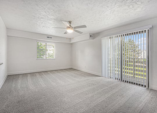 enlarged living room with ceiling fan at The Crossings Apartments, Michigan, 49508