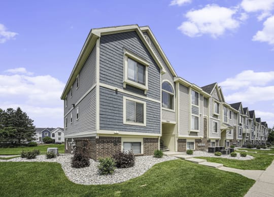 exterior apartment building with green lawn at The Crossings Apartments, Michigan, 49508