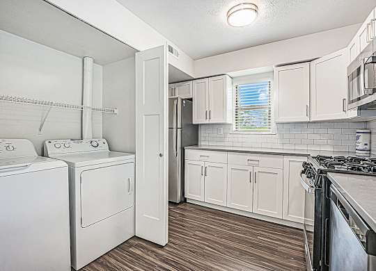 a kitchen with washer and dryer at The Crossings Apartments, Michigan, 49508