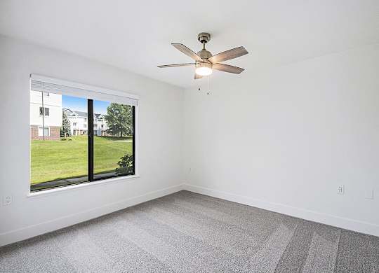 Spacious bedroom with large window at The Crossings Apartments, Grand Rapids, Michigan