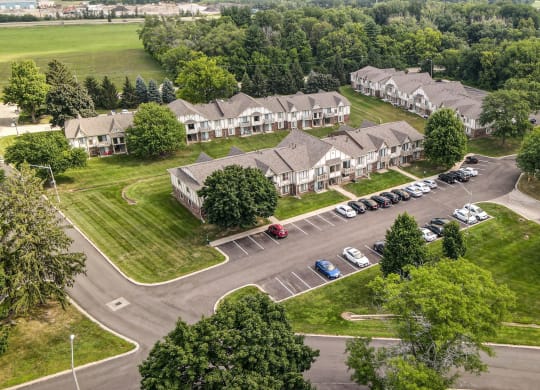 arial view of a subdivision with houses and parking lot at Beacon Hill and Great Oaks Apartments, Illinois, 61109