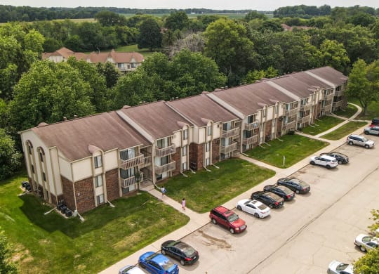 an aerial view of an apartment complex with cars parked in front at Beacon Hill and Great Oaks Apartments, Rockford, IL